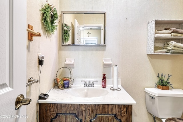 bathroom featuring vanity and toilet