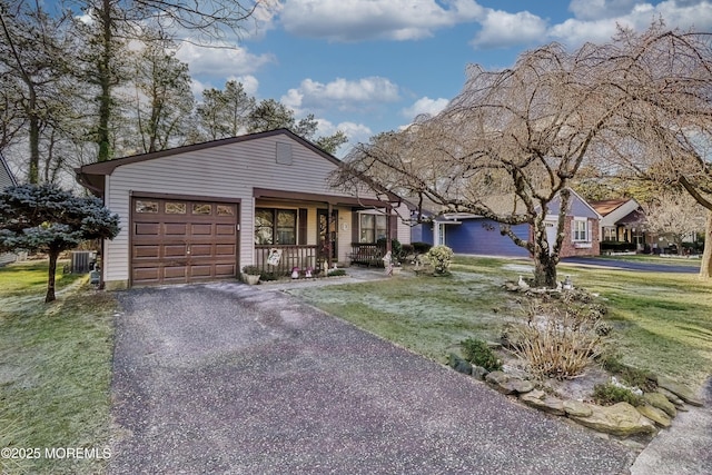 ranch-style home with central AC, covered porch, a front lawn, and a garage