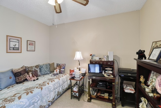 carpeted bedroom with a textured ceiling and ceiling fan