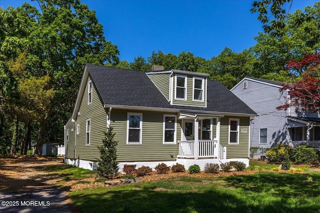 cape cod home with a front yard