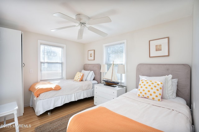 bedroom with ceiling fan and hardwood / wood-style floors