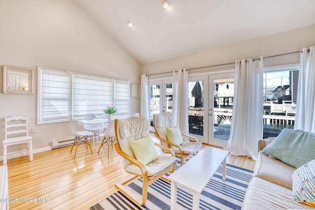 living room with baseboard heating, a wealth of natural light, french doors, and high vaulted ceiling