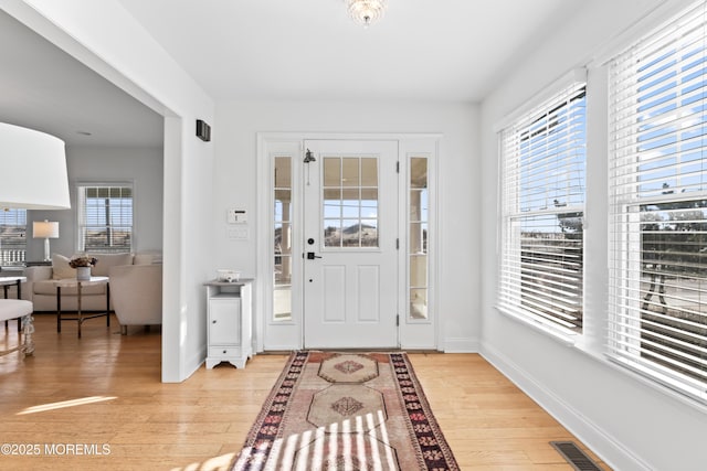 entrance foyer with a wealth of natural light and light hardwood / wood-style floors