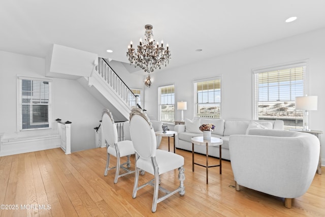 living room featuring light wood-type flooring and a chandelier