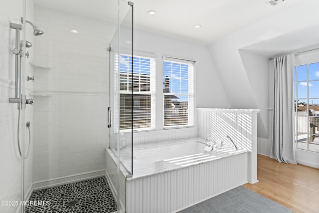 bathroom with separate shower and tub and wood-type flooring