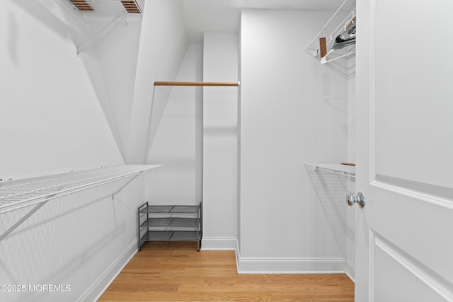 spacious closet with light hardwood / wood-style floors