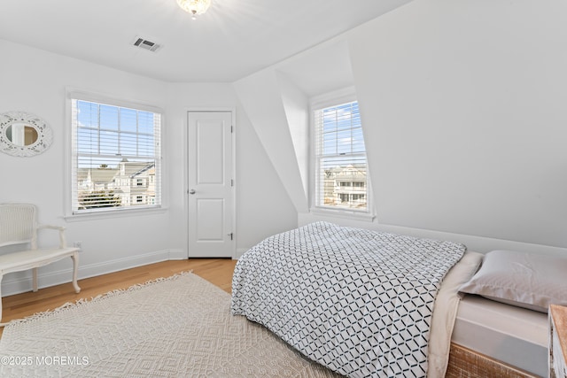 bedroom with wood-type flooring