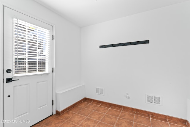 entryway with plenty of natural light and tile patterned floors