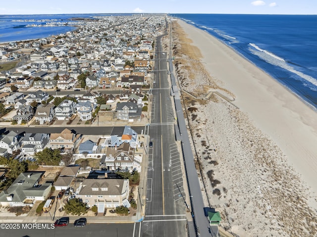 aerial view with a water view and a beach view