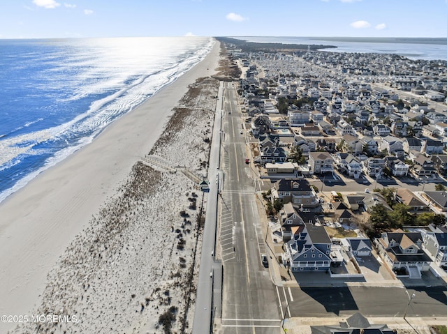 bird's eye view with a water view and a view of the beach