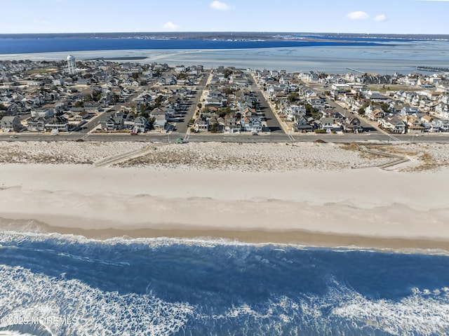 aerial view featuring a water view and a beach view