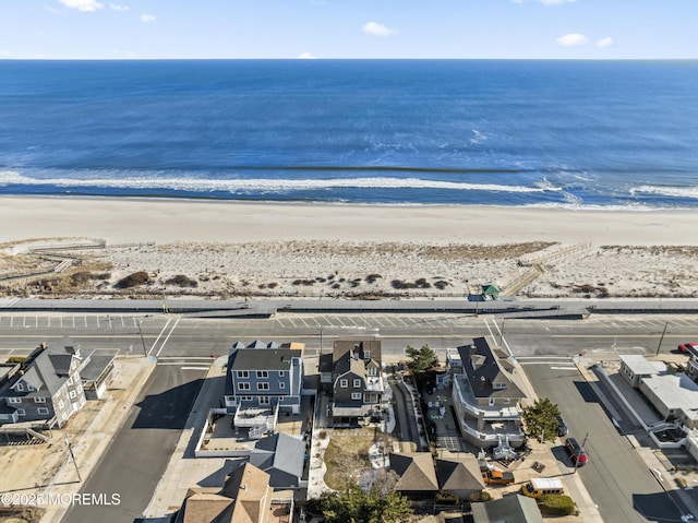 bird's eye view with a water view and a view of the beach