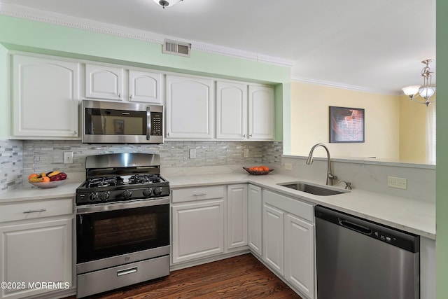 kitchen with white cabinets, appliances with stainless steel finishes, and sink