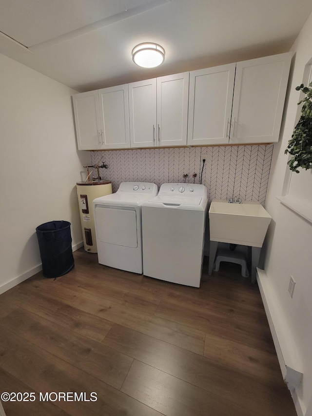 washroom featuring dark wood-type flooring, cabinets, electric water heater, and separate washer and dryer