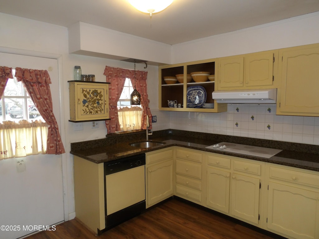 kitchen featuring white appliances, sink, a wealth of natural light, and tasteful backsplash