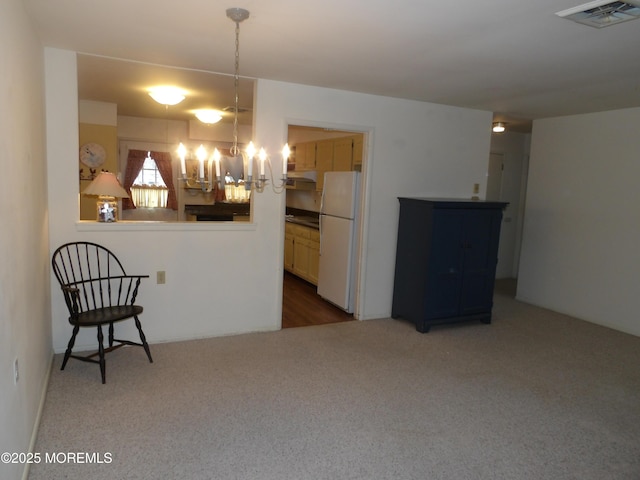 kitchen with carpet flooring, white fridge, and pendant lighting