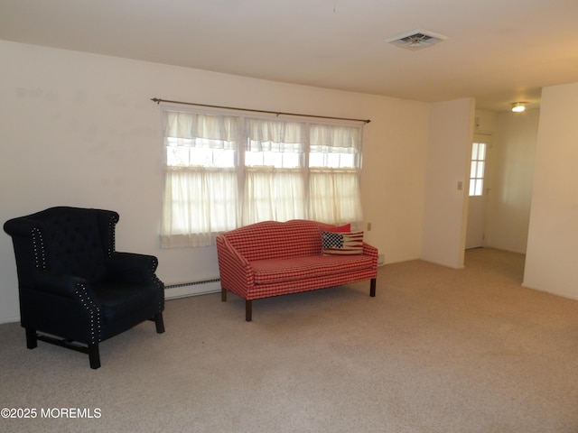 sitting room featuring light colored carpet and a baseboard heating unit