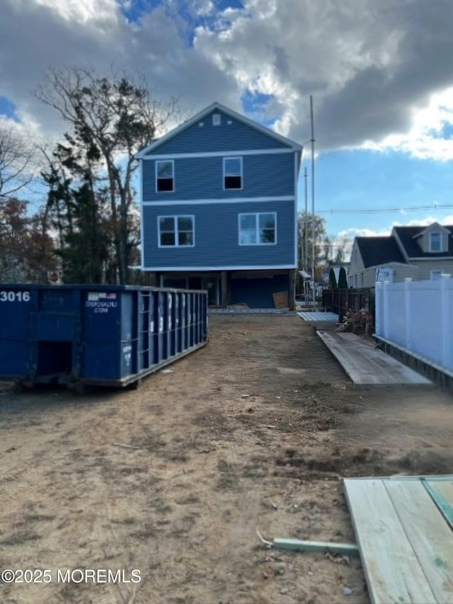 back of house featuring fence