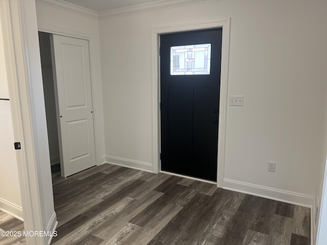 foyer entrance featuring baseboards, ornamental molding, and dark wood-style flooring