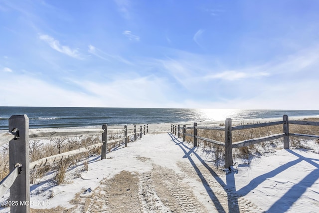 view of yard featuring a water view and a beach view