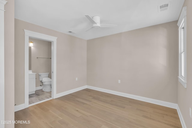 unfurnished bedroom featuring light hardwood / wood-style floors, ceiling fan, and ensuite bathroom