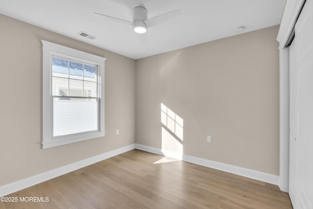 spare room with ceiling fan and light wood-type flooring