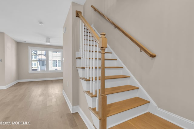 staircase with hardwood / wood-style flooring