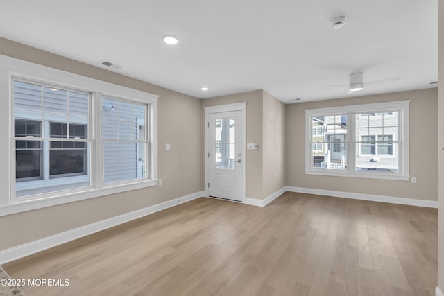 foyer entrance with ceiling fan and light hardwood / wood-style floors