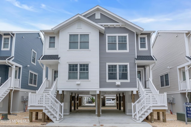 24 Shell Rd Unit 126, Mantoloking, NJ 08738 - raised beach house with stairs, a carport, and concrete driveway