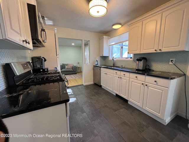 kitchen with dishwasher, white cabinets, black gas range oven, and sink