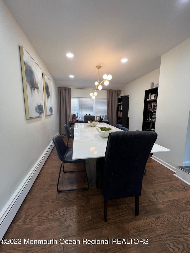 dining space featuring dark hardwood / wood-style floors, an inviting chandelier, and a baseboard heating unit