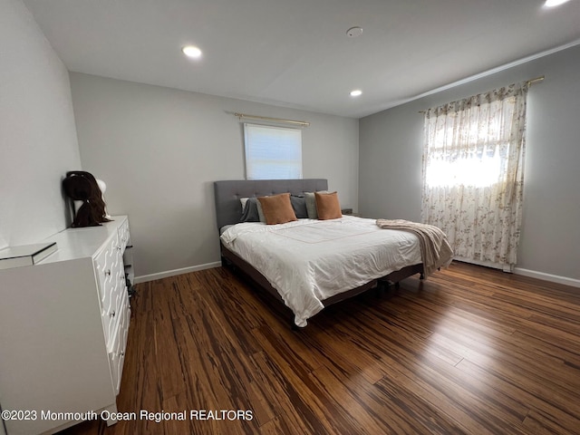 bedroom with dark wood-type flooring