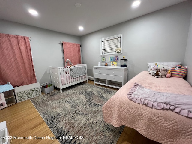 bedroom with dark hardwood / wood-style flooring