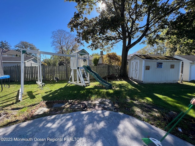 view of yard with a playground, a shed, and a trampoline