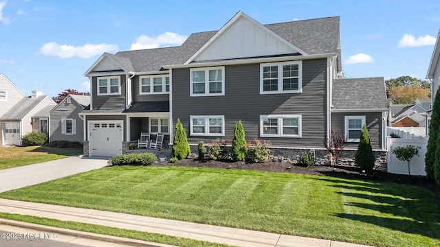 view of front of property featuring a front yard and a garage