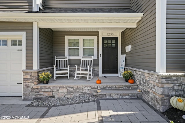 property entrance featuring a garage and covered porch