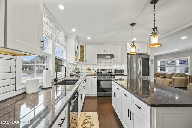 kitchen featuring decorative backsplash, sink, white cabinets, and appliances with stainless steel finishes