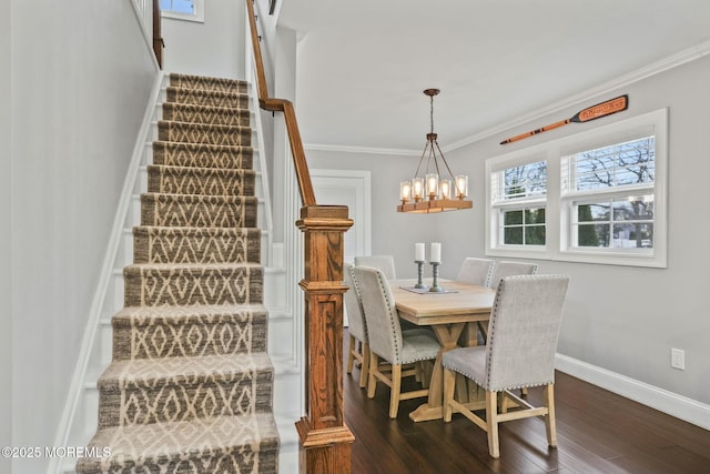 dining area with crown molding, dark hardwood / wood-style flooring, and a chandelier