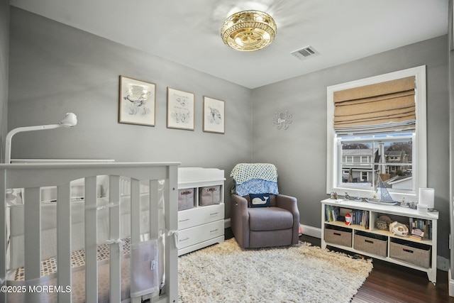 bedroom with dark hardwood / wood-style flooring