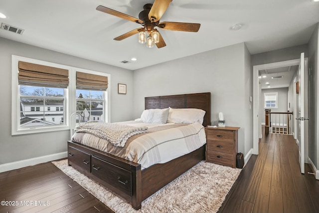 bedroom with ceiling fan and dark wood-type flooring