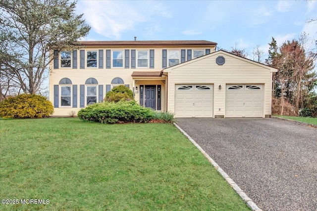 view of front of home featuring a garage and a front lawn