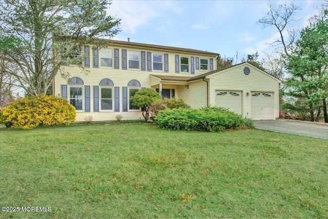 view of front of home with a front yard and a garage