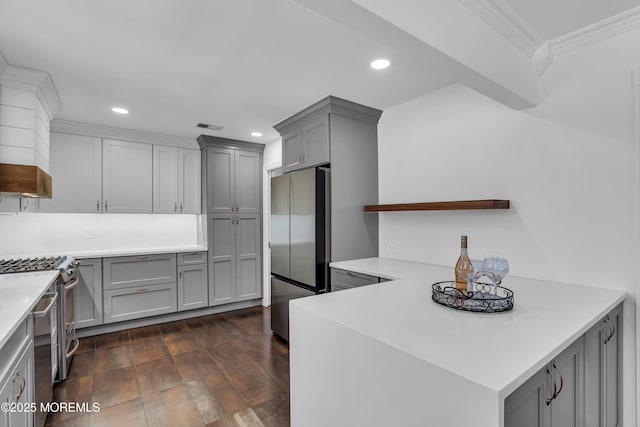 kitchen featuring stainless steel appliances, dark wood-type flooring, ornamental molding, and gray cabinetry