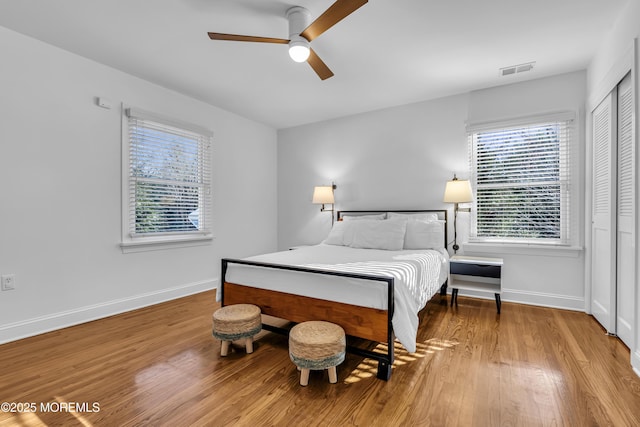 bedroom featuring a closet, ceiling fan, and light hardwood / wood-style floors