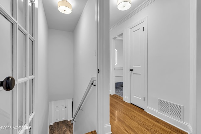 hallway featuring ornamental molding and hardwood / wood-style floors