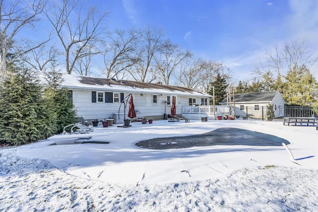 snow covered property featuring a covered pool