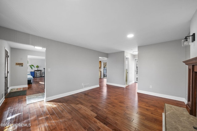 unfurnished living room featuring dark hardwood / wood-style flooring