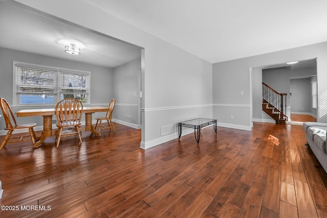 dining space with dark wood-type flooring