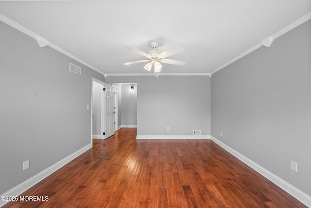 empty room with hardwood / wood-style flooring, ceiling fan, and crown molding