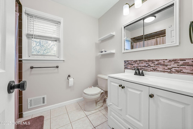 bathroom featuring toilet, vanity, backsplash, and tile patterned floors